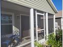 Cozy screened porch with outdoor seating perfect for relaxing and enjoying the outdoors at 1978 Lockett Ln, The Villages, FL 34762