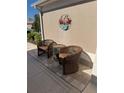 Cozy patio with wicker chairs and table, perfect for relaxing outdoors at 1985 Abordale Ln, The Villages, FL 32162