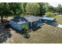 Charming single-story home with a metal carport and a fenced yard showcasing a well-maintained landscape at 201 W Mirror Lake Dr, Fruitland Park, FL 34731