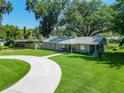 Charming single-story home with a circular driveway, well-manicured lawn, and inviting front porch at 203 Se 30Th Ave, Ocala, FL 34471