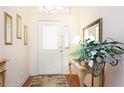 Inviting foyer with hardwood floors, decorative mirror, and elegant decor at 20631 Prince Ranier Pl, Leesburg, FL 34748