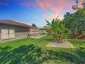 Expansive backyard featuring lush green lawn, mature trees, and a patio area perfect for outdoor entertaining at 24436 Madewood Ave, Leesburg, FL 34748