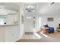 Bright foyer with high ceilings, decorative front door with tiled floors and an open floor plan at 26736 Cash Ct, Leesburg, FL 34748