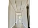 Hallway featuring modern lighting, neutral paint and hard surface flooring throughout at 3070 Sunscape Ter, Groveland, FL 34736