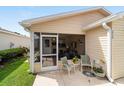 Charming screened patio with seating offers a relaxing outdoor living space at 312 Emmalee Pl, The Villages, FL 32162