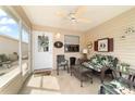 This cozy screened patio features comfortable seating and a ceiling fan at 312 Emmalee Pl, The Villages, FL 32162