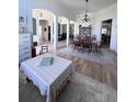 Open-concept living and dining area featuring hardwood floors, natural light, and comfortable seating at 326 Crystal Pond Ave, Deland, FL 32720