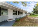 This home has a quaint front porch and well maintained yard with flowering bushes at 37132 Turner Dr, Umatilla, FL 32784