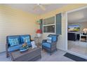 Cozy, well-decorated screened in patio with comfortable seating offering an inviting space to relax and unwind at 3756 Viscaya Ct, The Villages, FL 32163