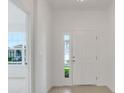 Bright foyer featuring tile flooring, a stylish front door with sidelight, and views into other rooms at 4118 Penelope Ave, Lake Wales, FL 33859