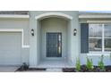 A welcoming covered entrance with a stylish front door and updated lighting fixtures at 4118 Penelope Ave, Lake Wales, FL 33859