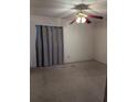 Bedroom with a ceiling fan, carpeted floor, and a window with curtains at 4294 Nimons St, Orlando, FL 32811