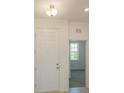 Bright entryway with a six panel door, ceramic flooring and a view to the outside at 5043 Abigail Dr, Lake Wales, FL 33859