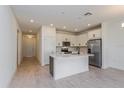 Modern kitchen with white cabinets, stainless steel appliances and a large island at 5043 Abigail Dr, Lake Wales, FL 33859