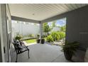 Cozy covered patio featuring comfortable seating and a lush garden view, perfect for relaxation at 5325 Zisa Ct, The Villages, FL 32163