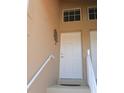 Inviting home entrance with staircase and decorative metal tree on wall at 5373 Compass Pt # 1, Oxford, FL 34484