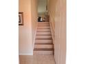 Elegant staircase featuring light hardwood steps and white trim at 5373 Compass Pt # 1, Oxford, FL 34484