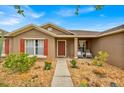 Inviting front entrance with colorful landscaping, accent plants, and decorative chairs, adding curb appeal at 597 Skyridge Rd, Clermont, FL 34711