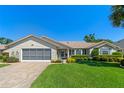 Charming single-story home featuring a well-manicured lawn, two-car garage, and neatly trimmed landscaping at 6608 Borg, Leesburg, FL 34748