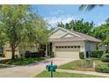 Charming single-story home boasts a brick driveway, attached garage, and lush landscaping in a serene neighborhood at 791 Wolf Creek St, Clermont, FL 34711