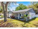 Single Gathering home boasting a covered front porch, mature trees, and stone accents at 8158 Bucksaw Dr, Orlando, FL 32817