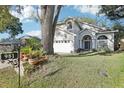 Charming home exterior featuring lush front lawn and brick walkway leading to the entrance at 981 Piedmont Oaks Dr, Apopka, FL 32703