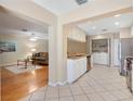 Open-concept kitchen seamlessly connected to the living area with stainless steel appliances at 1037 Willow Dr, Leesburg, FL 34748