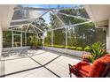 Enclosed patio with beautiful backyard views, perfect for enjoying the outdoors at 1037 Willow Dr, Leesburg, FL 34748