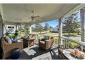 Relaxing screened porch with comfortable wicker seating and views of the neighborhood at 1172 Fiesta Key Cir, Lady Lake, FL 32159