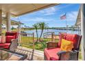 Inviting back porch with comfortable seating and serene water views, complete with an American flag at 1401 W Highway 50 # 142, Clermont, FL 34711