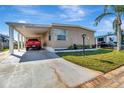 Exterior view of home with covered carport and driveway at 1401 W Highway 50 # 142, Clermont, FL 34711