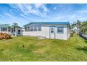 Exterior view of the mobile home showcasing its backyard at 1401 W Highway 50 # 143, Clermont, FL 34711