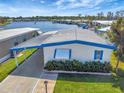 Mobile home near lake with a well-maintained lawn and a view of the lake at 1401 W Highway 50 # 143, Clermont, FL 34711