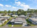 A pleasant aerial view of the neighborhood showing a single story home with mature landscaping and a double carport at 150 Hickory Ln, Eustis, FL 32726