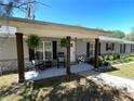 Inviting front porch with wooden pillars, comfortable seating, and decorative plants creating a welcoming entrance at 1650 Sundance Dr, St Cloud, FL 34771