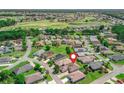 Beautiful aerial view of home in golf course community with nearby green space and golf cart paths at 17787 Se 114Th Ave, Summerfield, FL 34491