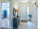 Welcoming foyer with tiled flooring, elegant decor, and a view into the home at 1806 Estafana Way, The Villages, FL 32159