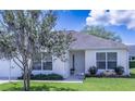 Inviting single-story home with lush landscaping and a welcoming front porch at 1806 Estafana Way, The Villages, FL 32159
