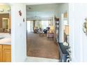 Open-concept living area with neutral tones, plush carpeting, and natural light at 1806 Estafana Way, The Villages, FL 32159
