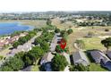 An aerial view showcasing the property's location near a lake and golf course at 2126 Burley Ave, Clermont, FL 34711