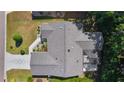 Overhead shot showcasing the home's roof, landscaping, screened lanai, and driveway at 2482 Ansley Path, The Villages, FL 32162