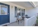 Cozy front porch with seating area, perfect for relaxing and enjoying the neighborhood at 2482 Ansley Path, The Villages, FL 32162
