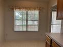 Bright kitchen window with blinds offers natural light and backyard views at 25801 Belle Helene, Leesburg, FL 34748