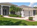 Charming home with well-maintained landscaping, including green shrubs and colorful flowerbeds framing the entrance at 27027 Old English Ct, Leesburg, FL 34748