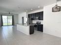 Modern kitchen with stainless steel appliances, granite countertops, and a spacious island at 2721 Picasso Ct, Kissimmee, FL 34743