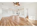 Bright and open living room with hardwood floors and a ceiling fan at 27510 Discover Ct, Leesburg, FL 34748