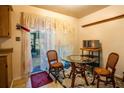 Bright breakfast nook with seating for two, accented by floral curtains and sliding doors at 30011 County Road 437, Sorrento, FL 32776