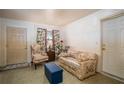 Cozy living room with floral patterned furniture and natural light from the window at 30011 County Road 437, Sorrento, FL 32776