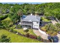 Charming two-story home featuring a screened porch, attached garage, and beautiful landscaping at 306 N Clayton St, Mount Dora, FL 32757