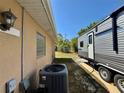 Home exterior view showing an air conditioning unit and RV parked in the yard at 31728 Nutmeg Ave, Eustis, FL 32736